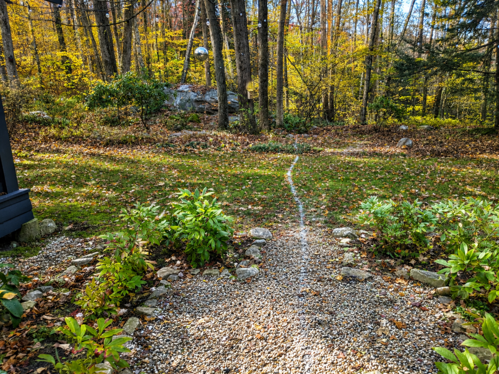 Wooded outdoor area before construction of the Berkshire Rock Garden and cedar hot-tub setting