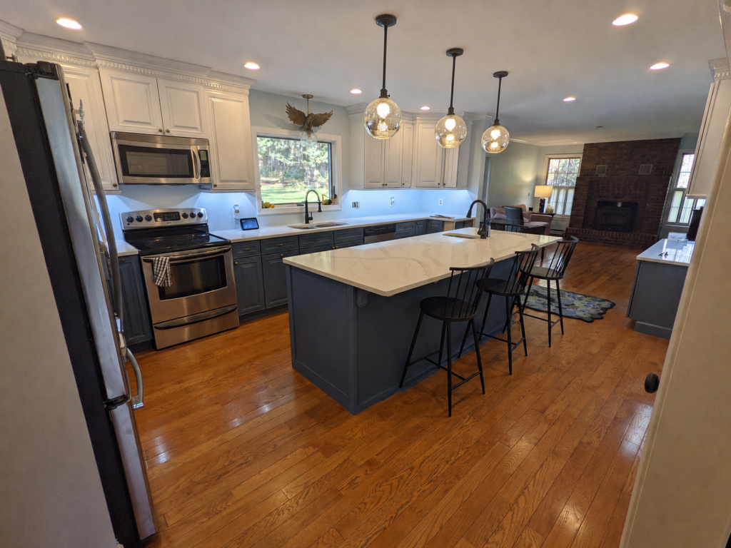 Completed Lakeside Kitchen with painted two-tone cabinets, white quartz countertops and a single-level island with seating