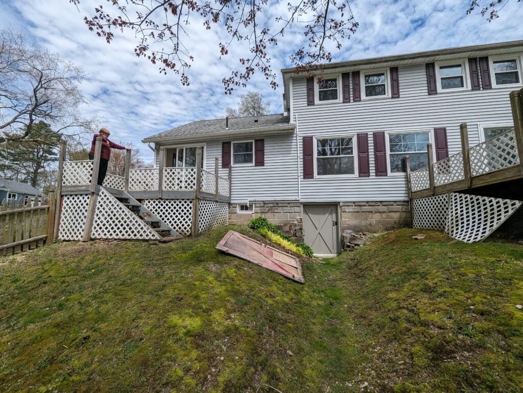 Existing disconnected rear decks before construction of the new deck and three-season room