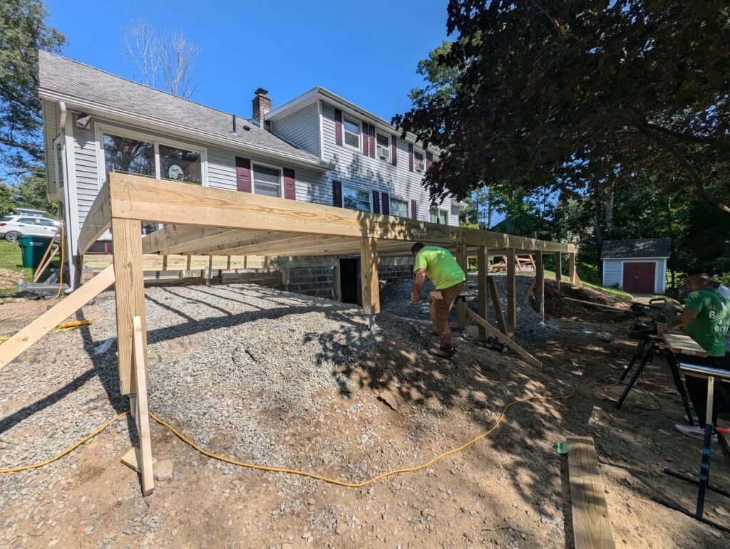 Freestanding 50-by-16-foot deck framing supported by helical piles during construction