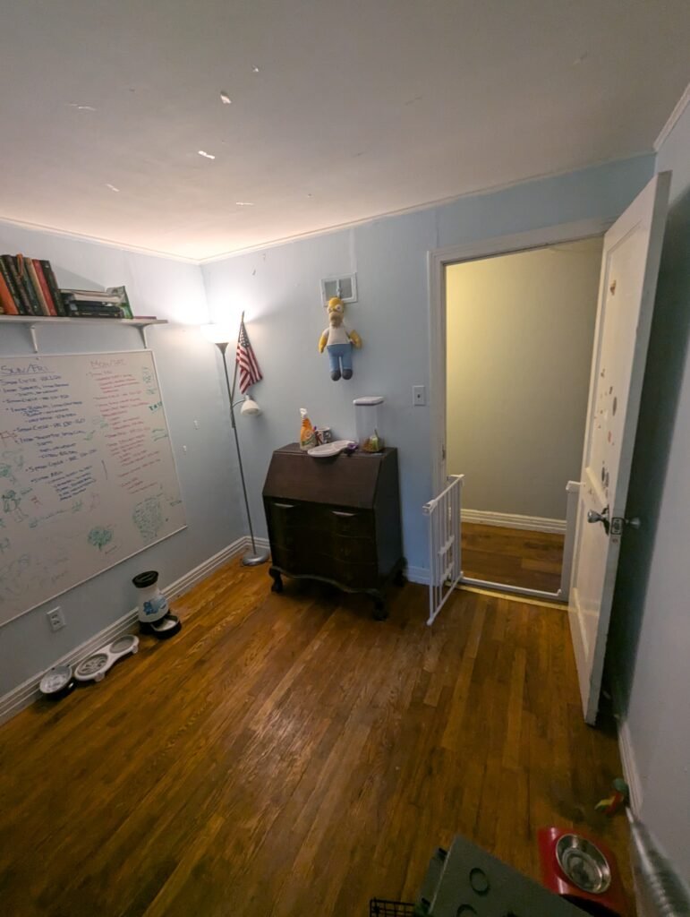 Original bedroom entrance and hardwood flooring before the bathroom conversion