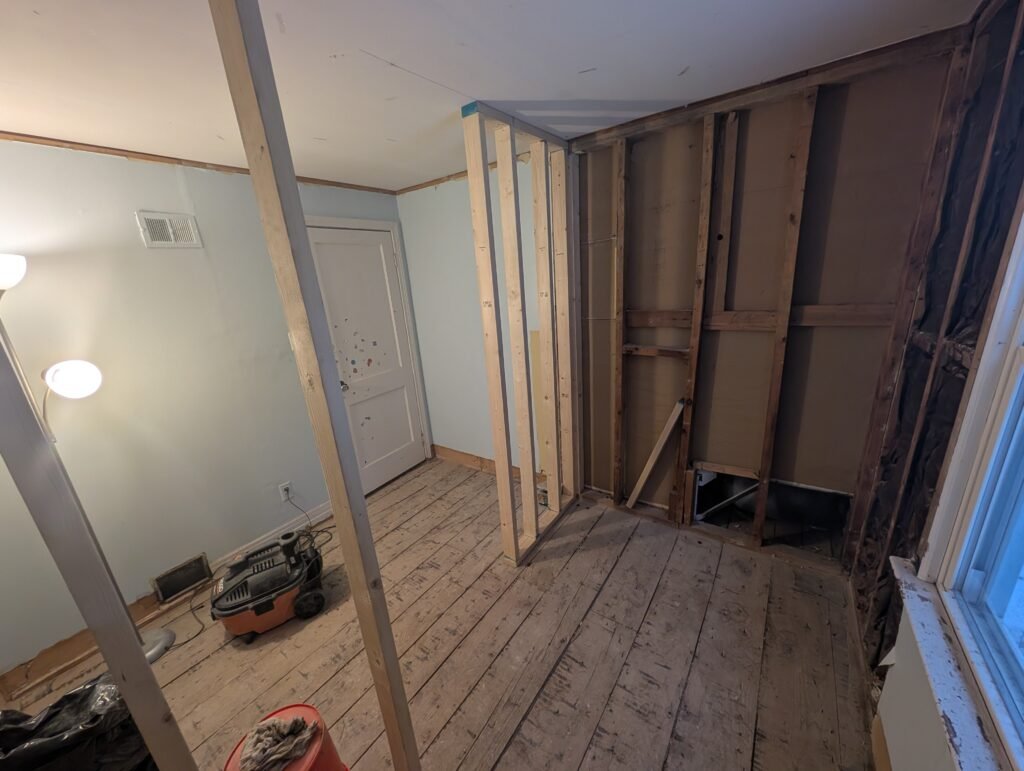 New bathroom layout under construction after the bedroom walls and flooring were opened