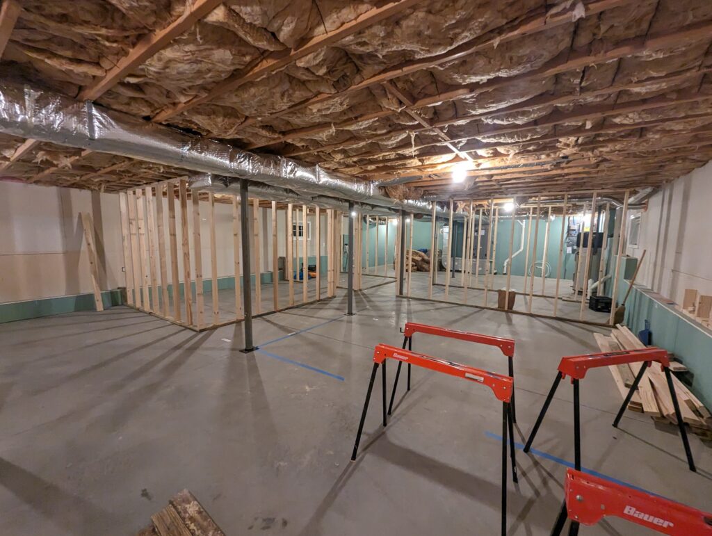 Lower House apartment during construction with finished walls, a ceiling grid and new electrical work