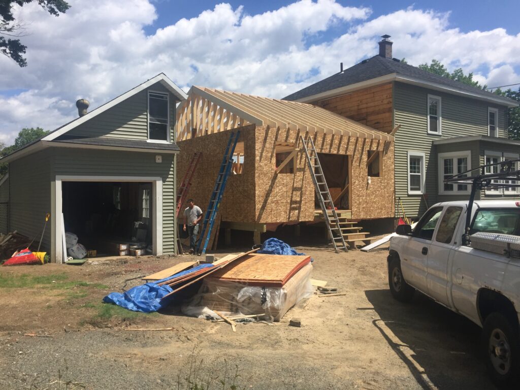 Wall sheathing and roof framing during construction of the traditional home addition