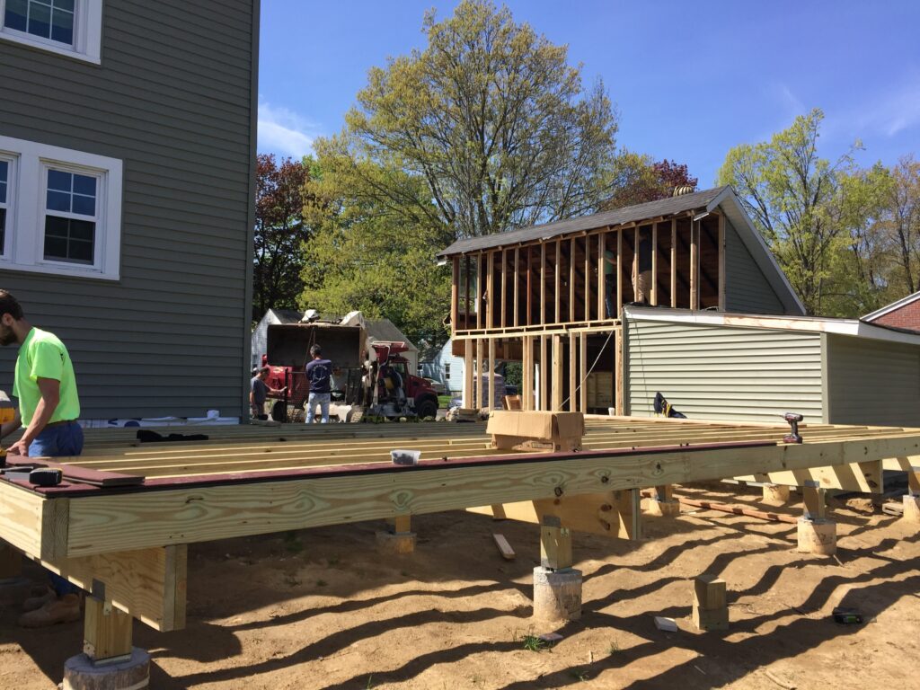Pressure-treated floor framing installed between the existing home and detached garage during construction