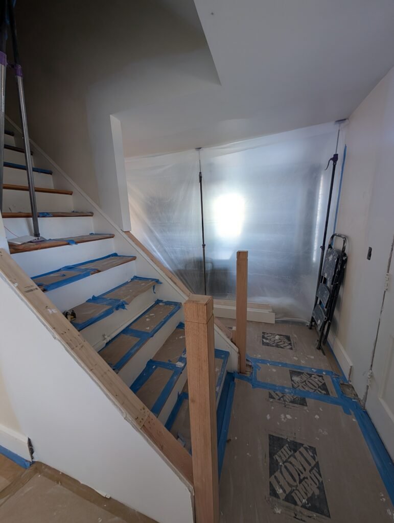 Galley kitchen during renovation with the suspended ceiling removed and older wiring exposed